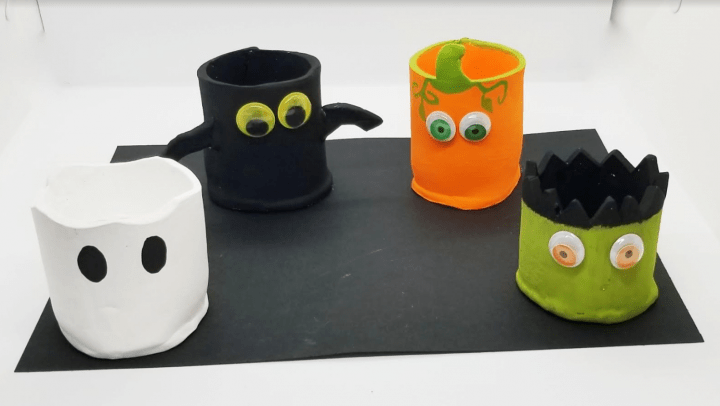 Halloween clay crafts shows four clay pots with eyes.