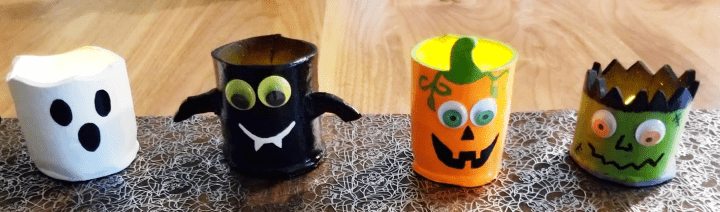 DIY Halloween clay pots shows a ghost, bat, pumpkin and Frankenstein clay pot craft.