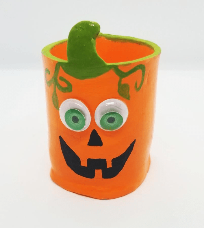 DIY halloween clay pots shows a pumpkin pot.