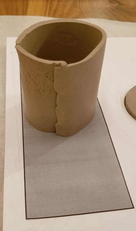 DIY clay crafts shows a clay cylinder.