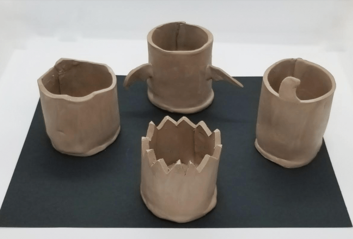 diy halloween clay pot shows 4 clay pots that are not dry.