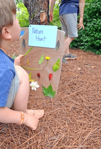 fall outdoor learning activities shows a child holding a nature hunt page made from real nature items.