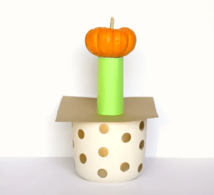 fall stem shows a mini pumpkin on a paper tower.