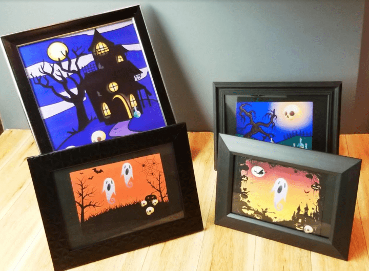 halloween escape room shows four picture frames with halloween pictures.