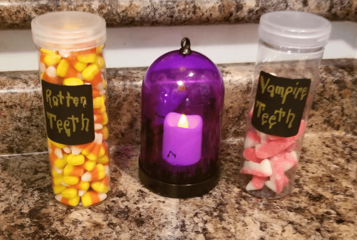 Make a Halloween Escape Room  shows two jars with candy and a flameless candle.