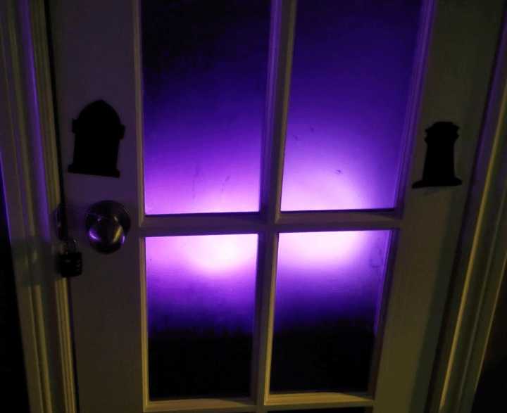 Make a Halloween Escape Room shows a purple glow of something behind the door.