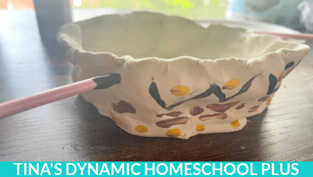 easy clay crafts shows a pinch pot bowl being painted.