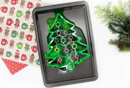 Christmas STEM shows a frying pan with a tree cookie cutter and fizzing liquids.