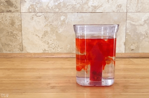 Science experiments for kids shows a cut with red liquid mixing in it.