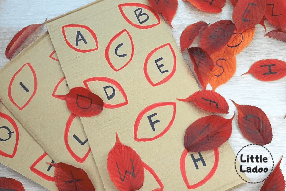 kindergarten learning centers shows a board with leaves traced and letters printed in them.