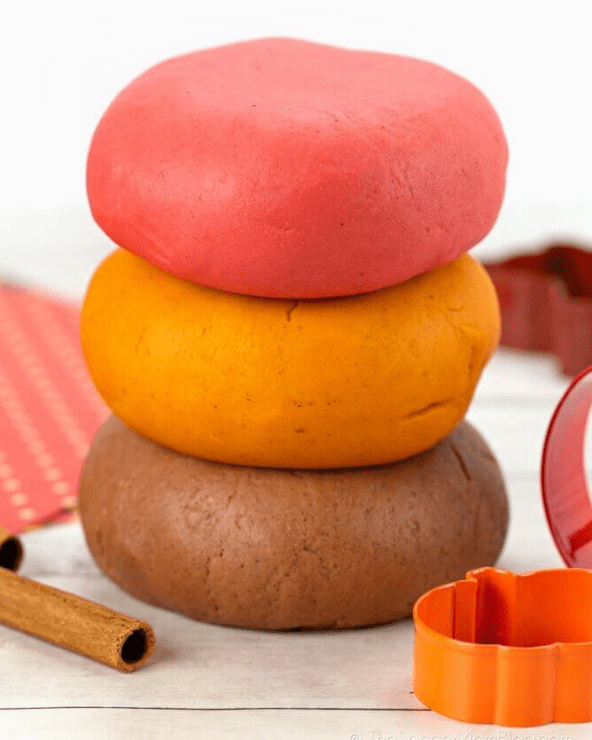 kindergarten learning activities shows three layers of play dough, red, orange and brown.