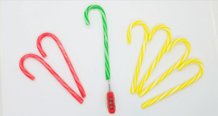 DIY Christmas Escape Room shows two red, a green and four yellow candy canes.