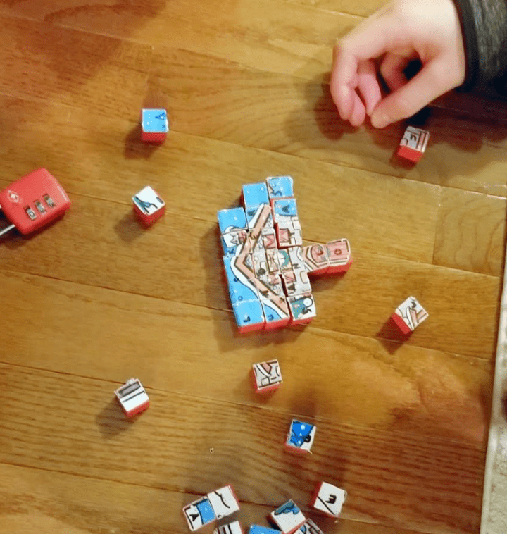 escape room ideas shows a child putting a cube puzzle together.