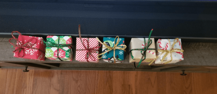 Christmas shows six small gifts set in a line.