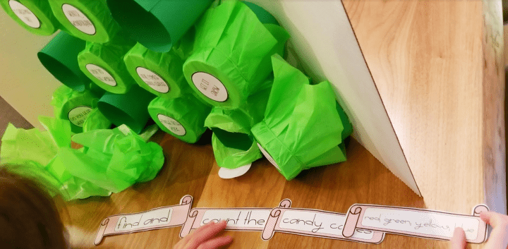 DIY Christmas Escape Room shows four strips of paper with clues on them.