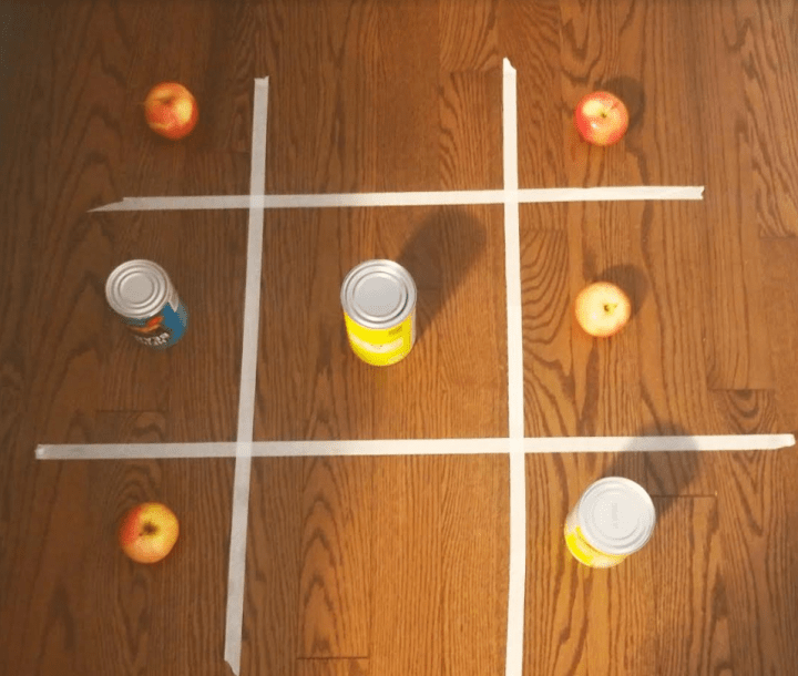 family games night shows a tic tac toe board made from tape on the floor.