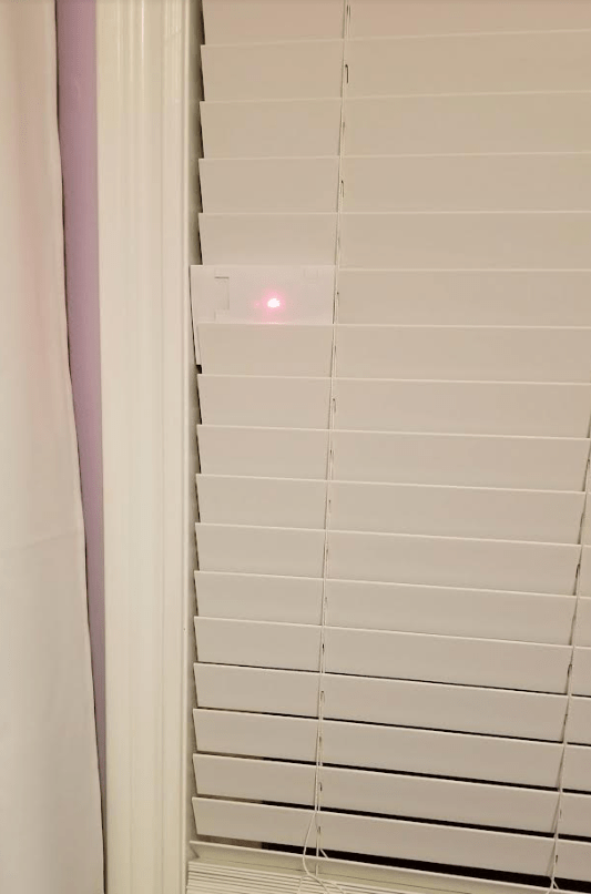 escape room ideas shows a laser dot on blinds.