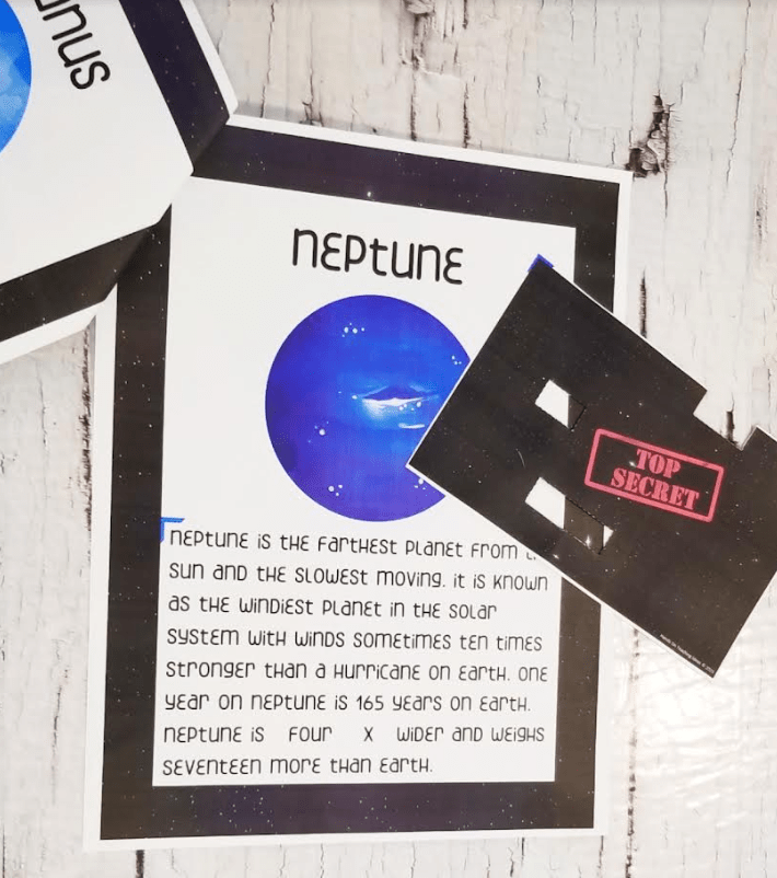 escape room puzzles shows a printed page about Neptune and a sheet that says top secret.