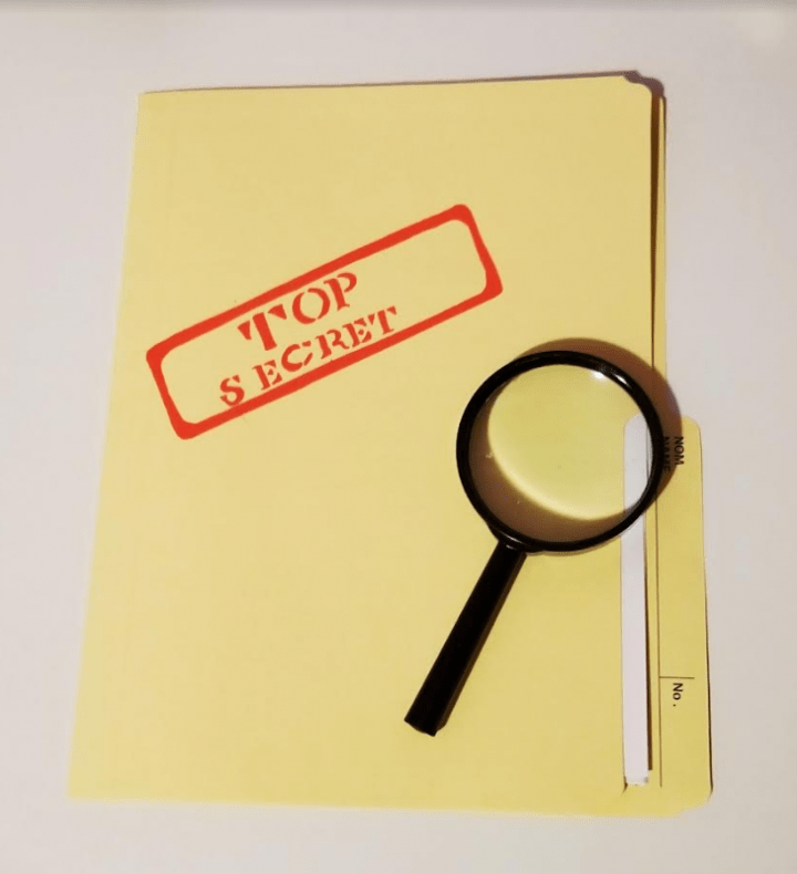 escape room challenge shows a file with the words top secret and a magnifying glass.