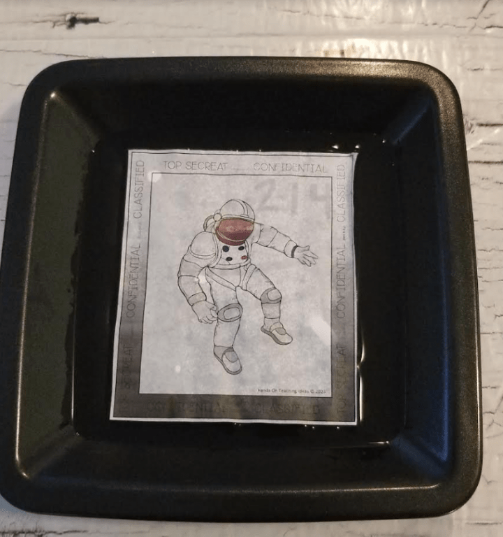 escape room at home shows a picture of an astronaut in water.