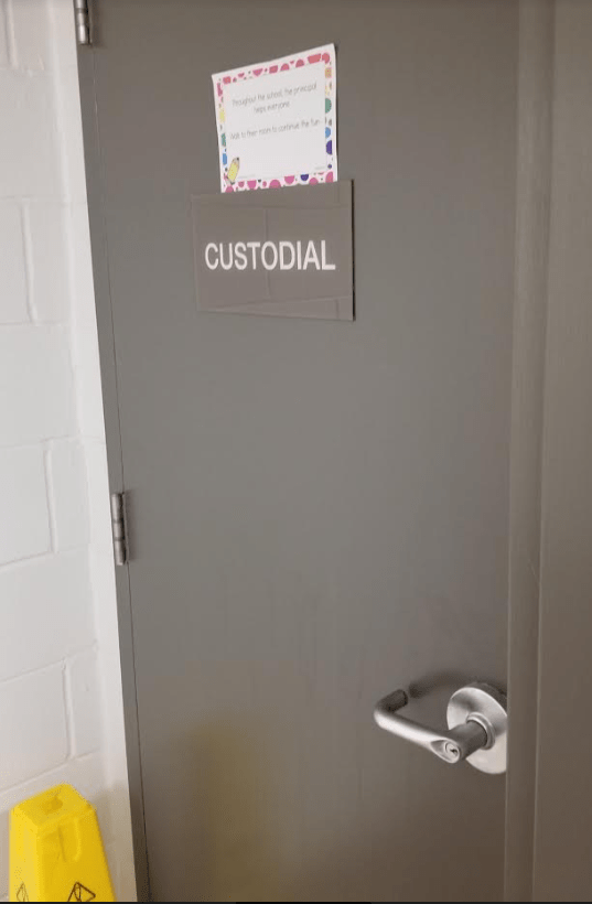 classroom escape room shows a door that says custodial and a clue card.