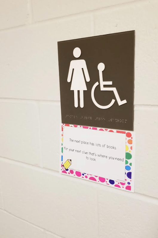 free school scavenger hunt shows a washroom sign and clue card.