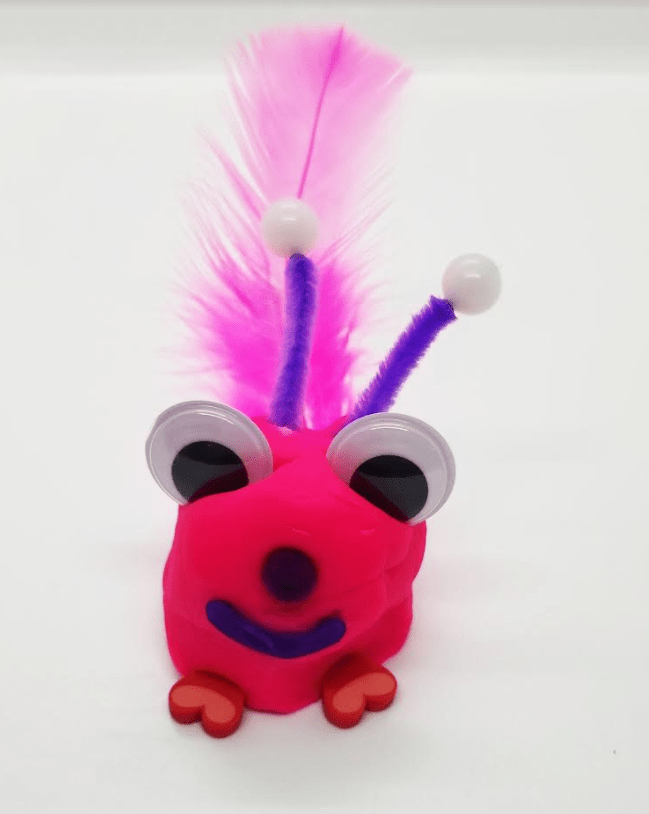 valentines day stem shows a pink lovebug with googly eyes and feather tail.