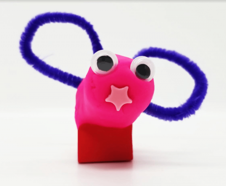 valentines day stem activity shows a lovebug for valentines day made from clay and pipecleaners.