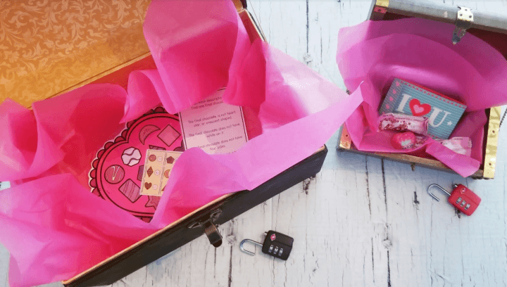 valentines escape room shows two treasure chests filled with Valentine themed items.