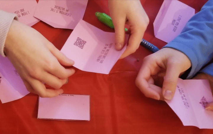 valentines escape room shows children opening and looking at the messages inside of valentines.