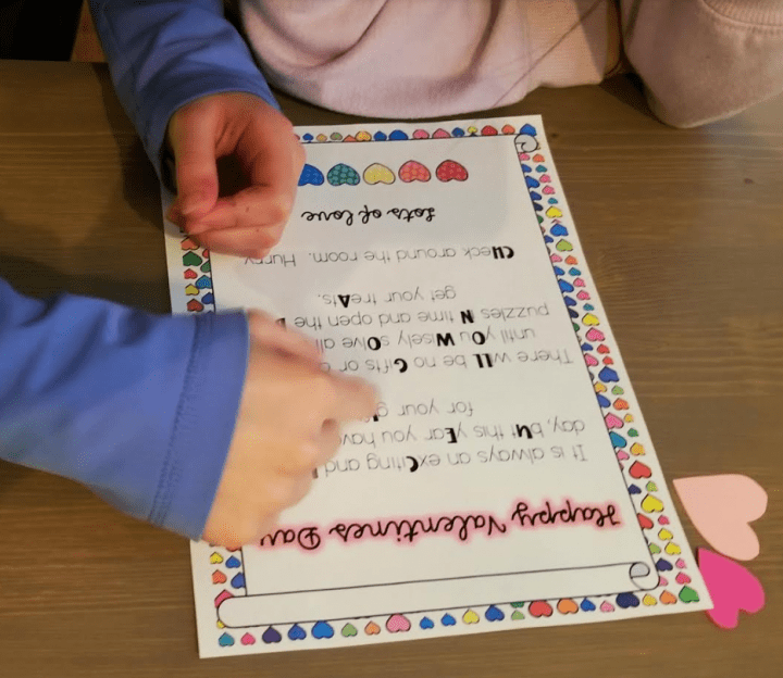 diy valentines escape room shows children reading a welcome to your escape room letter.