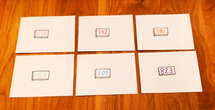 how to make an escape room lock box ideas shows six envelopes with three digit numbers on each.