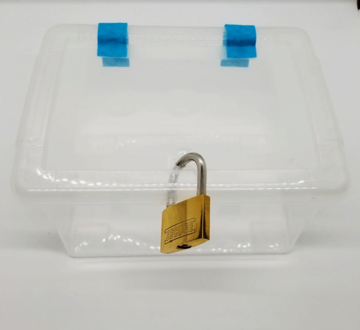 how to make an escape room lock box ideas shows a plastic container with a lock through it and felt hinged on the back.