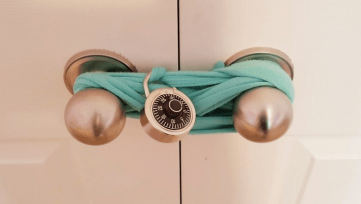 how to make an escape room lock box ideas shows a closet locked with a felt belt and secured with a lock.