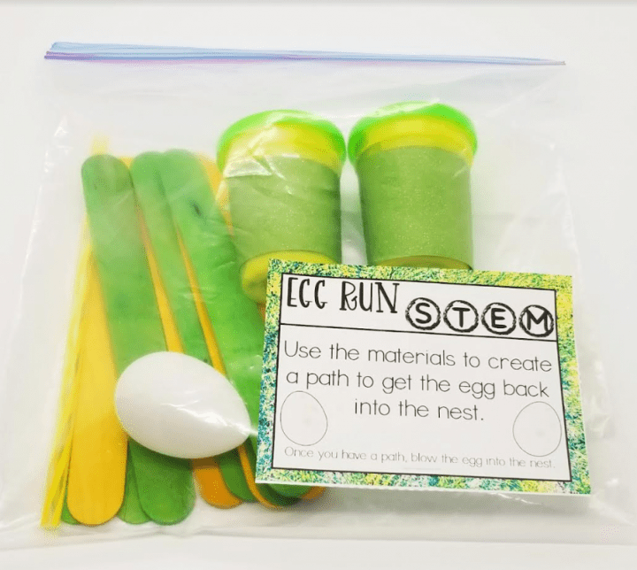 spring stem activity shows a bag with dough, an egg, sticks and a printed card that says egg run stem use the materials to create a path to get the egg back into the nest.