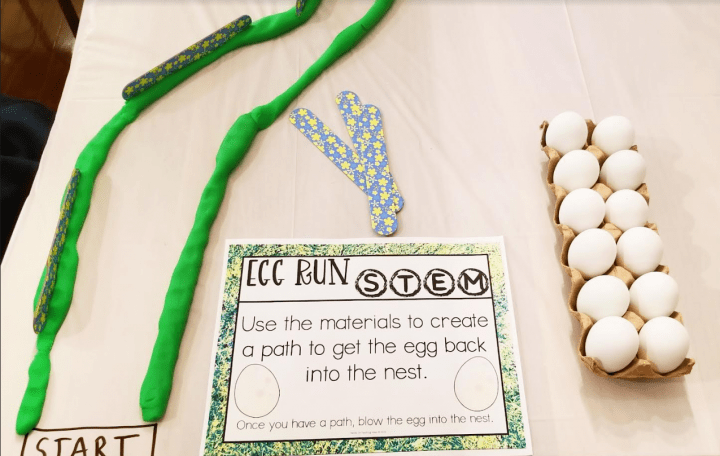 spring stem activity shows a page that says egg run stem use the materials to create a path to get the egg back into the nest.  There is also a carton of eggs.