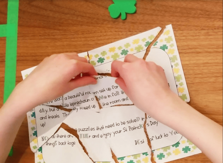 escape room puzzles shows a child putting together a ripped up puzzle.
