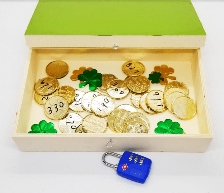 st. patrick's day escape room shows a box full of coins with numbers on them.
