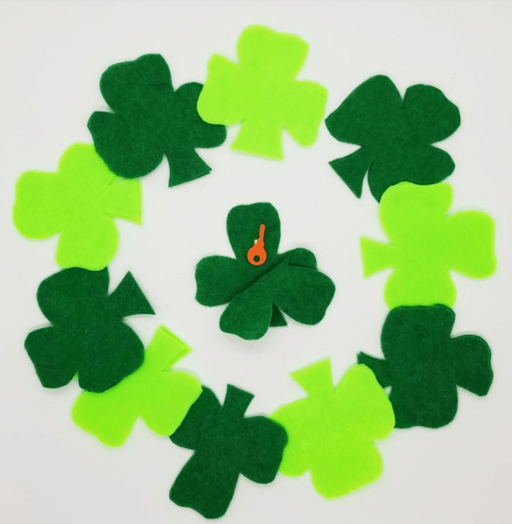 st. patrick's day escape room shows a shamrock being glued together with a hot glue gun.