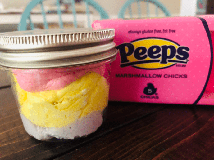 Easter science experiment shows a jar with different colored peeps marshmallow.