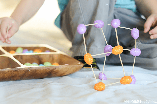 Easter STEM activity shows a child building a tower from jelly beans and toothpicks.