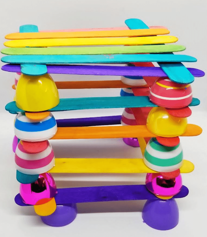 Easter STEM activity shows a structure made from Easter eggs and popsicle sticks.