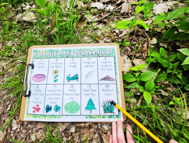 free printable scavenger hunt shows a printed page of the hunt and a child pointing at one of the items to find.