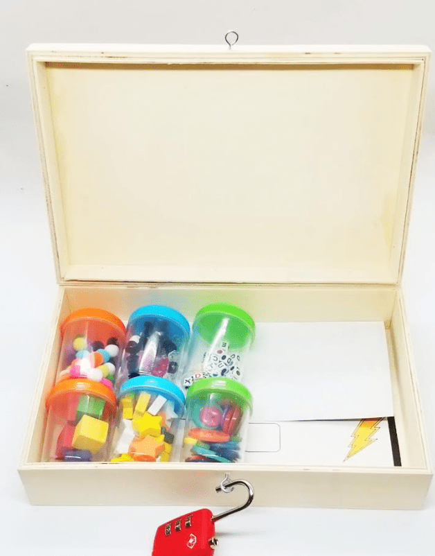 stem escape room shows a unlocked box with six container filled with colorful little items.