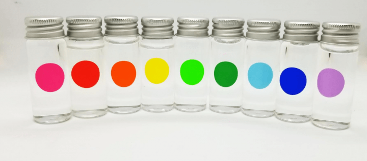 stem escape room shows nine jars each filled with water and a colored dot on each.