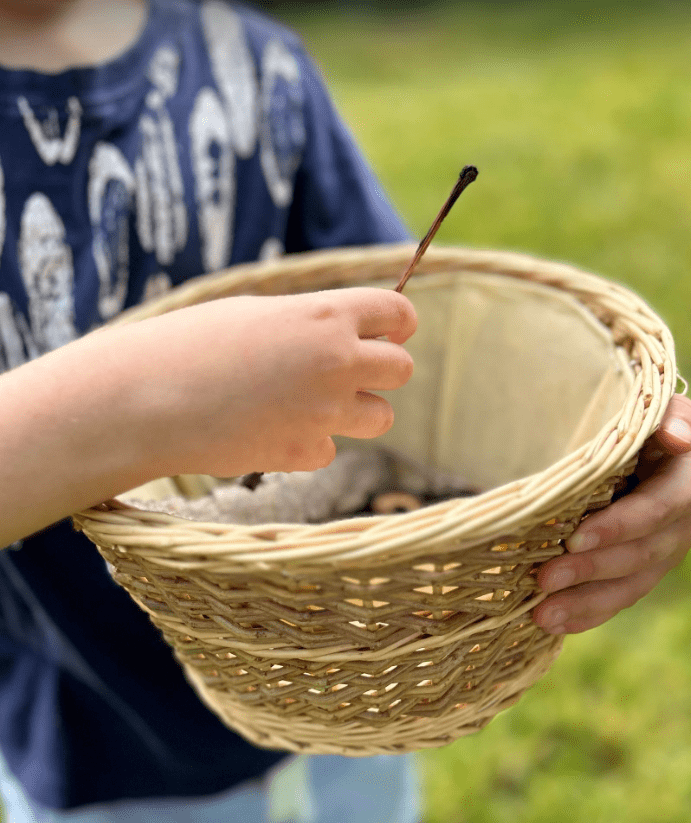 fathers day nature craft shows a child with a wicker basket.
