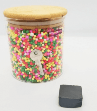 escape room puzzle ideas shows a jar with a key in it and magnet block.