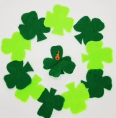 escape room puzzle ideas shows a bunch of green felt shamrocks and the middle one shows a key in the shamrock.