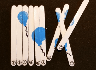 escape room puzzle ideas shows popsicle sticks with blue balloons painted on.