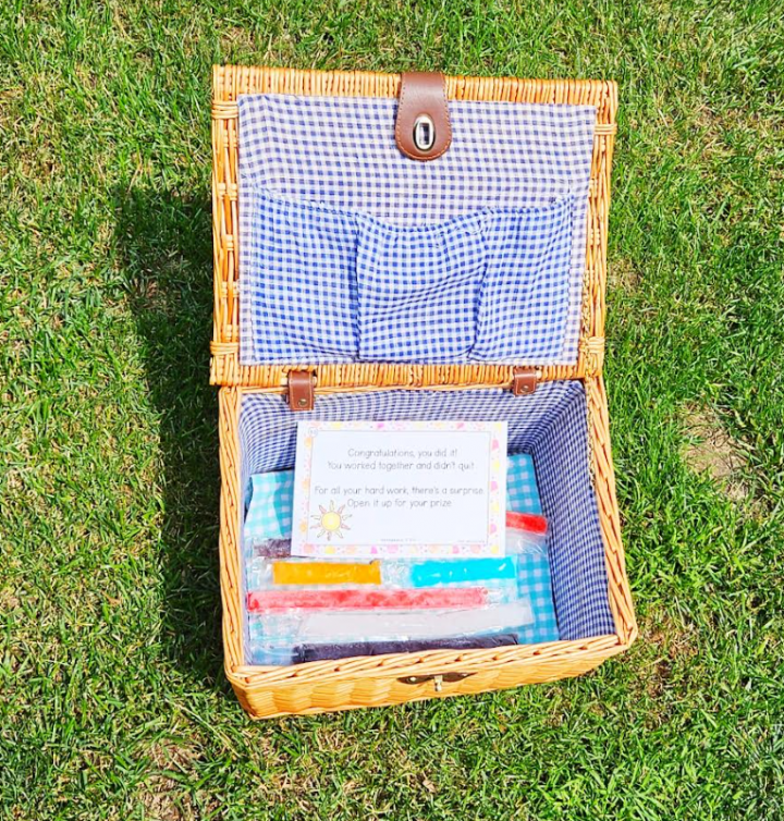 summer scavenger hunt shows a picnic basket with freezies and a clue inside.